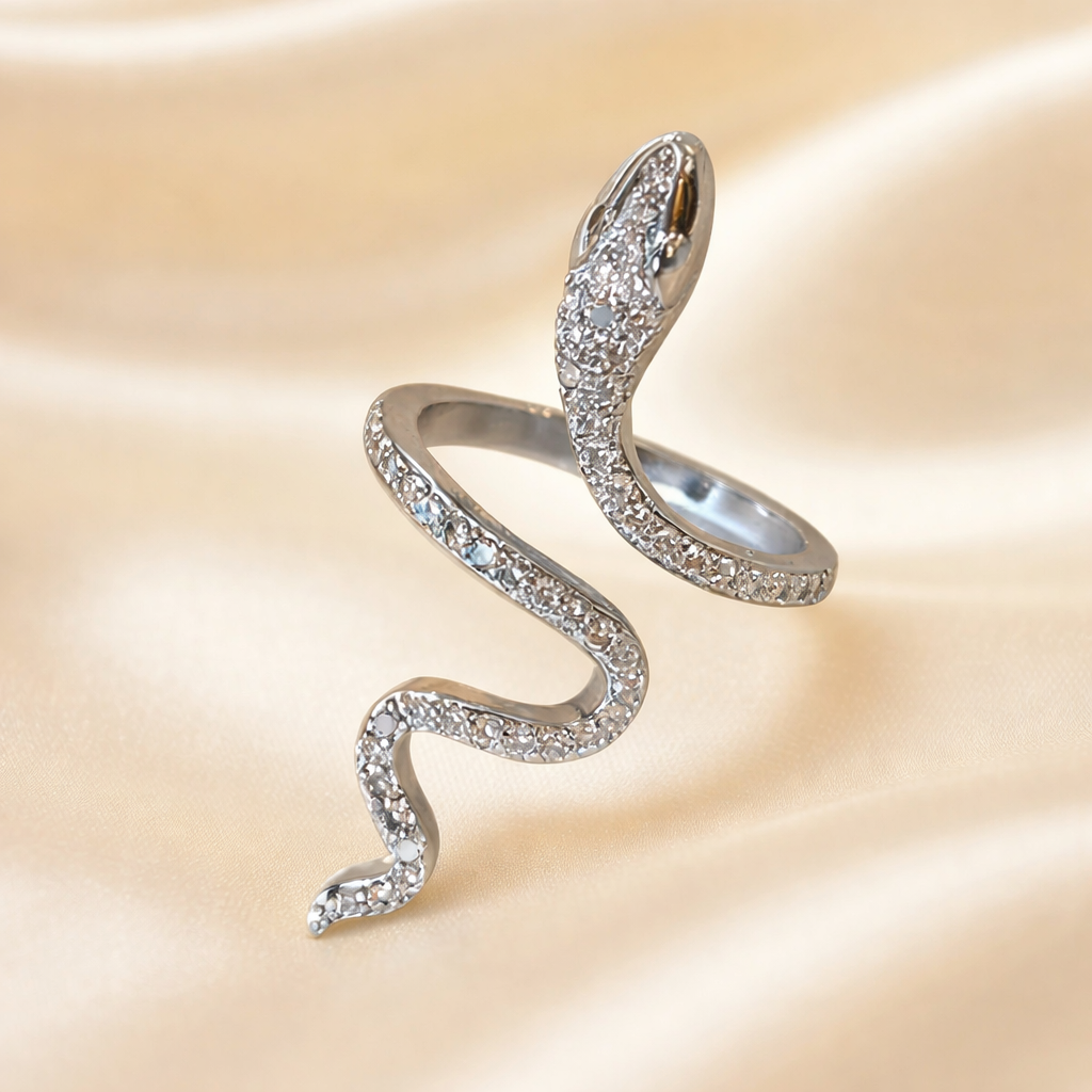 Silver snake-shaped earring on a beige background