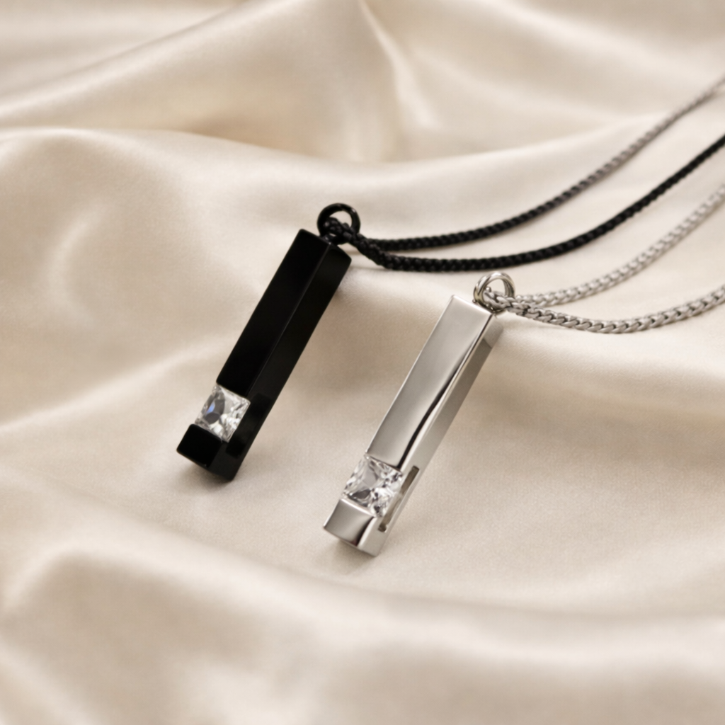 Two necklaces with pendant pendants on a beige fabric background