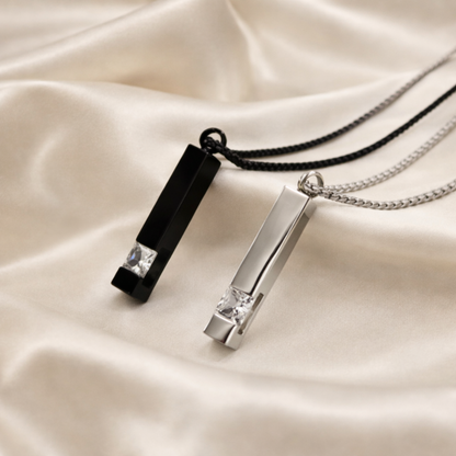 Two necklaces with pendant pendants on a beige fabric background