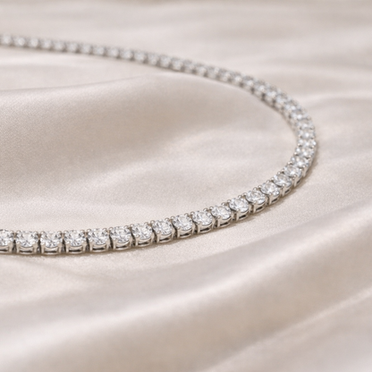 Diamond tennis necklace on a satin surface